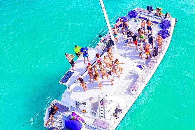 Catamaran Cruise with Snorkeling & Parasailing - Getting on board after hotel pickup near Los Corales beach
