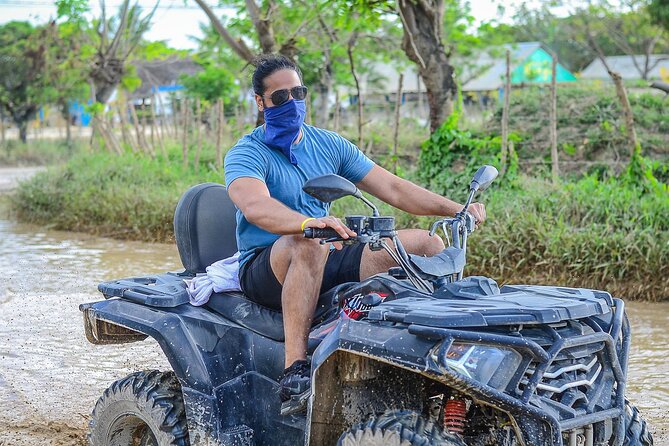 Explore Macao Beach with ATV Tours Punta Cana - Macao Beach: sand, waves, and limestone cliff views