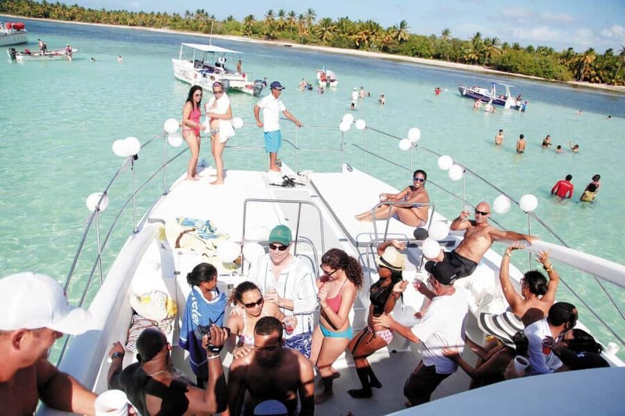 From Bavaro, Punta Cana: Boat Party, Snorkeling, Drinks, Snacks, and Transportation - The catamaran party vibe: slide, music, snacks, and dancing