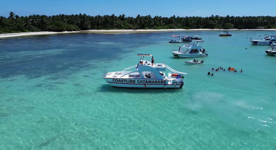 Punta Cana: Catamaran Tour with Reef Snorkeling and Open Bar - The Natural Pool Stop in Bavaro, waist-deep calm and drink runs