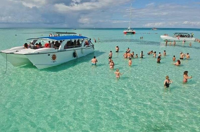 Saona Island Full Day Tour Lunch and Transportation Included - The return catamaran party: snacks, unlimited drinks, and dancing